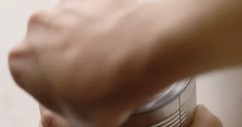 Women's hands open a can of corn. Canned food closeup. Video stock 249525628