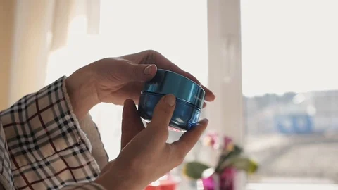 Women's hands open a jar of face cream Stock Footage 106610866
