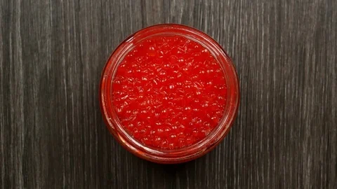 Women's hands open a lid from a jar of red caviar. Top view Stock Footage 84074529