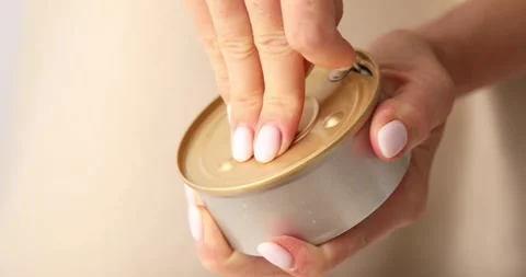 Women's hands open a tin of brie cheese. Stock Footage 249225631