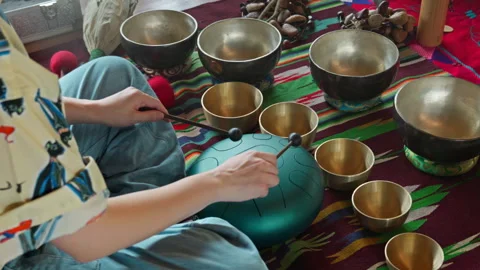 Women's hands playing on a  hang pad make a musical ceremony in a gazebo. Stock Footage 341238276