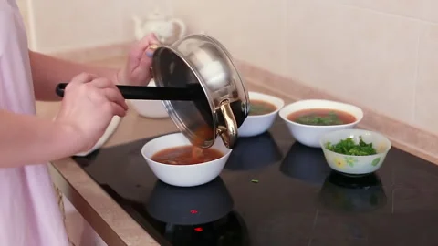 Womens hands pour soup Stock Footage 163608839