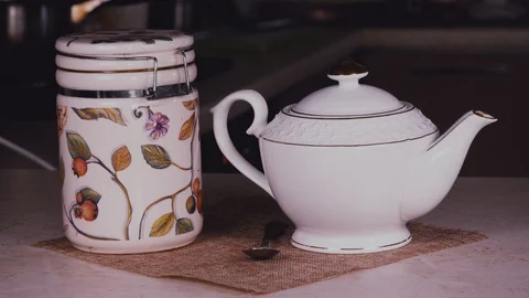 Women's hands pour tea into the kettle close-up Stock Footage 102306423