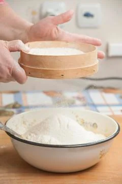 Women's hands preparing flour before baking pie Stock Photos
