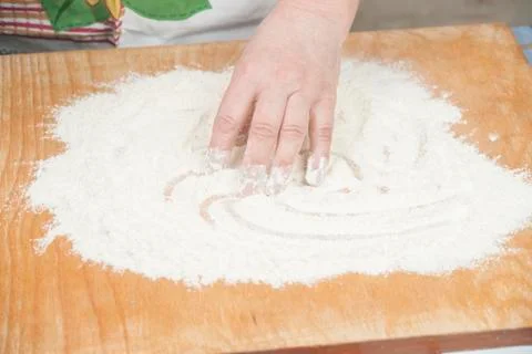 Women's hands preparing flour before baking pie Stock Photos