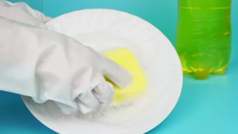 Women's hands in protective gloves with sponge and plate. Stock Footage 232214858