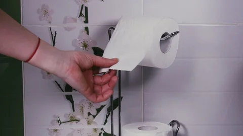 Women's hands pulling toilet paper Stock Footage 103166757