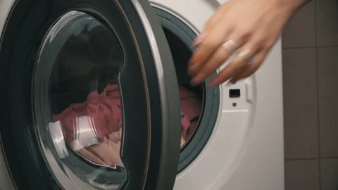 Women's Hands Put Clothes in a Modern Washing Machine Stock Footage 168483604