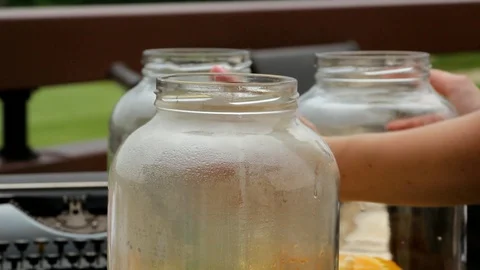 Women's hands put on the table two large cans for lemonade, close-up Stock Footage 87092017