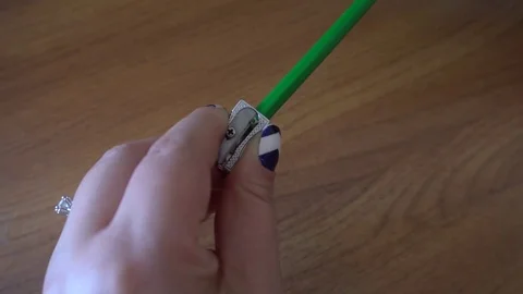 Women's hands sharpening pencil sharpener Stock Footage 76212840