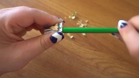 Women's hands sharpening pencil sharpener Stock Footage 76212883
