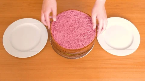 Women's hands shift the cakes of a different color biscuit in different plates Stock Footage 109374237