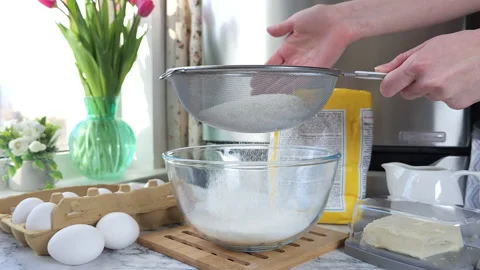 Women's hands sift wheat flour through a sieve Stock Footage 237817965