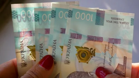 Womens hands sort out banknotes with a face value of one thousand Ukrainian Stock Footage 316316408