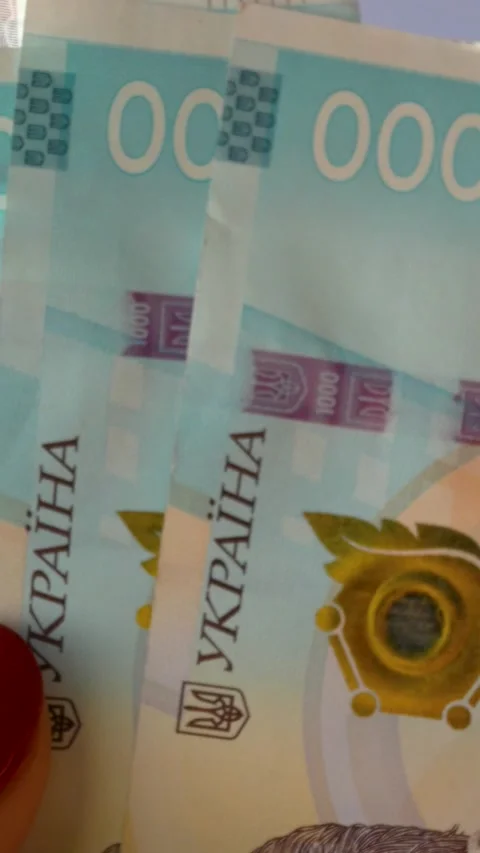Womens hands sort out banknotes with a face value of one thousand Ukrainian Video stock 317849445