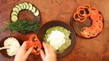 Women's hands spread vegetables on a plate Stock Footage 85493710
