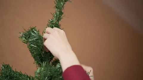 Women's hands spreading green branches of the New Year's festive artificial tree Stock Footage 142297720