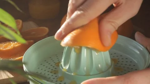 Women's hands squeeze juice from tangerine Stock Footage 146521353