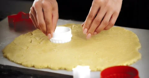 Women's hands squeeze out a white round mold on a shortbread dough Stock Footage 182832385
