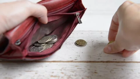 Women's hands stack coins rubles in red cats above the table Stock Footage 201641484