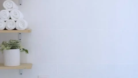 Women's hands stack a stack of clean towels on a shelf. Stock Footage 251518198