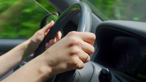 Women's hands on the steering wheel Stock Footage 90918444