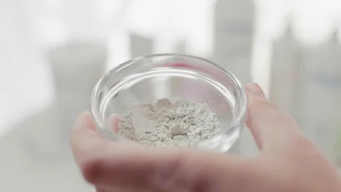 Women's hands stir cosmetic mask in a bowl. Close-up. 库存影片 105862425