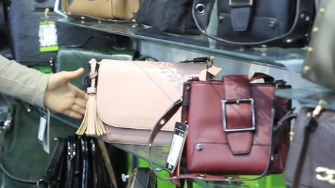 Women's hands in the store choose a backpack Video stock 98790071