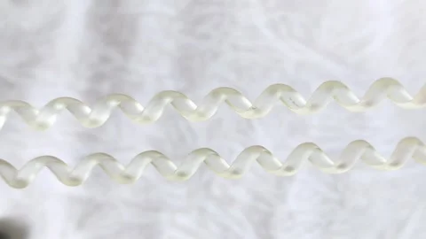 Womens hands stretch a spring-loaded hair band. Hair accessories. Stock Footage 313979187