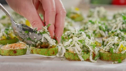Women's hands stuff zucchini with cheese, herbs and pepper. Stock Footage 270146202