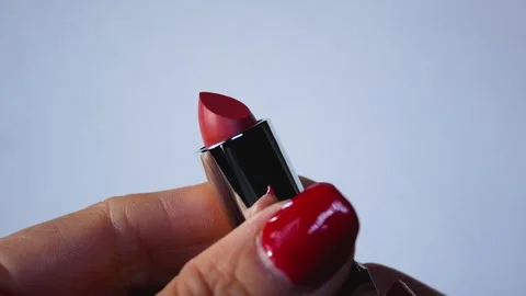 Womens hands take out of the package and unscrew the red lipstick. Stock Footage 316316504