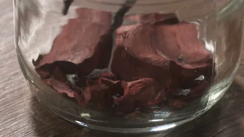 Women's hands take some dark red substance from glass with a tweezer Stock Footage 89675377