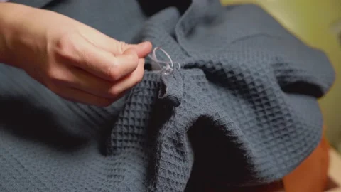 Women's hands with thread and needle sews torn clothes. Stock-Footage 141955003