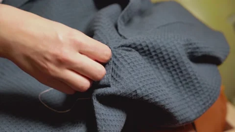 Women's hands with thread and needle sews torn clothes. Video stock 141955009