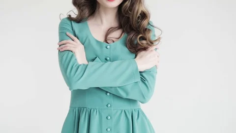 Women's hands touch the chic gray dress,, white background, close-up, 50 fps Stock Footage 105007657