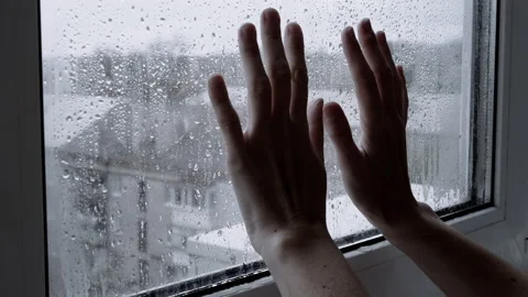 Women's Hands Touch the Wet, Misted Window. Close-up. 4K 動画素材 236087488