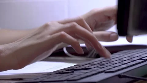Women's hands type on a computer keyboard. Typing and writing text on a laptop Stock Footage 148560308