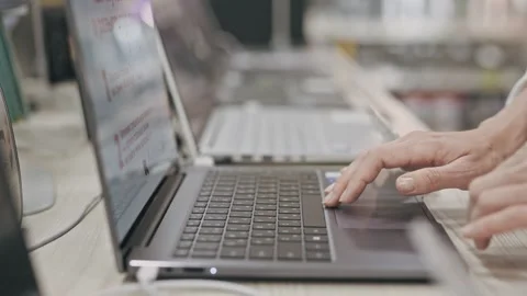 Women's hands typing on the keyboard of two laptops alternately. A freelance I.T Stock Footage 252080500