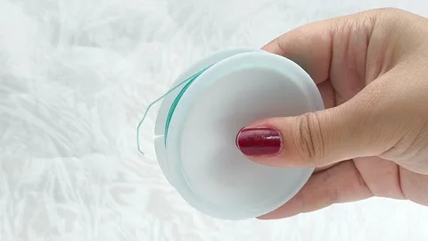 Womens hands unwrap plastic wire for beading. Elastic blue wire. Stock Footage 314308445