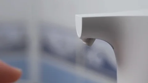 Women's hands use an automatic dispenser with liquid soap and wash under water. Stock Footage 129503510