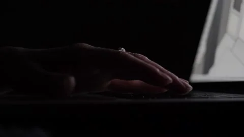 Women's hands use the laptop's touchpad in the dark. Stock Footage 143899786
