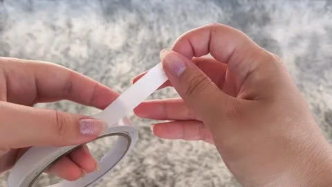 Womens hands use scissors to cut off double-sided tape. Video stock 315152718