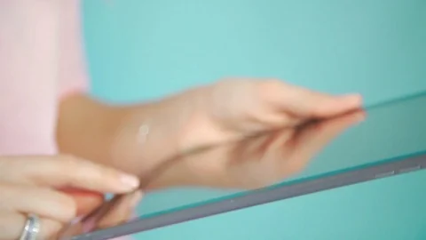 Women's hands use a tablet: a touch screen. A woman is using a tablet Stock Footage