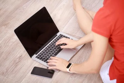 Women's hands using mobile phone and laptop computer Stock Photos