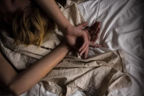 Women's hands on a white background on the bed style background screensaver p Stock Photos