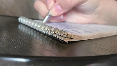 Womens hands write with a pen in a notebook Stock Footage 313108625