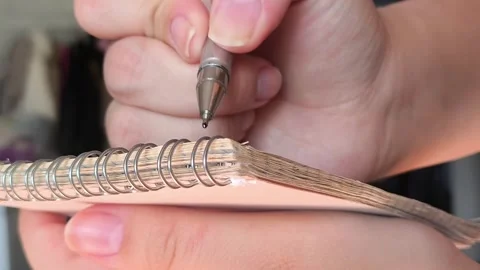 Womens hands write with a pen in a notebook Stock Footage 313108845