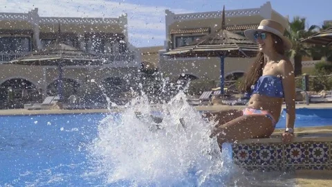 Women's legs and splashes in the pool Video stock 83682989