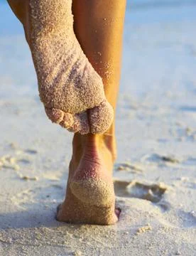 Women's legs on a beach Foto stock