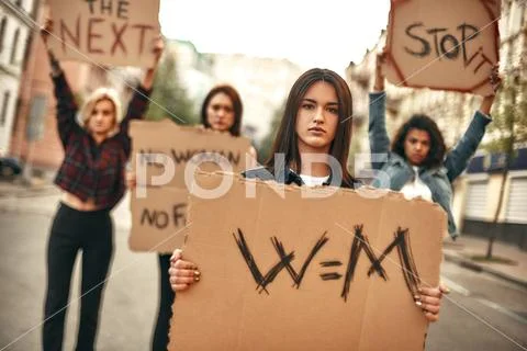 Women's march. Confident and young female protesting for equality and holding a Stock Photos